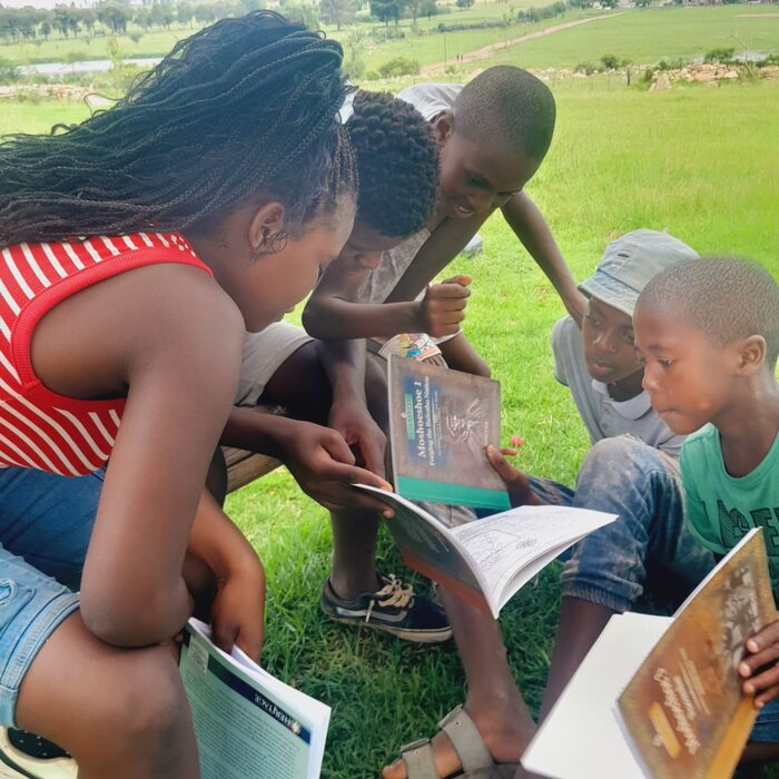 A pupil reading a book on local history alongside a classmate